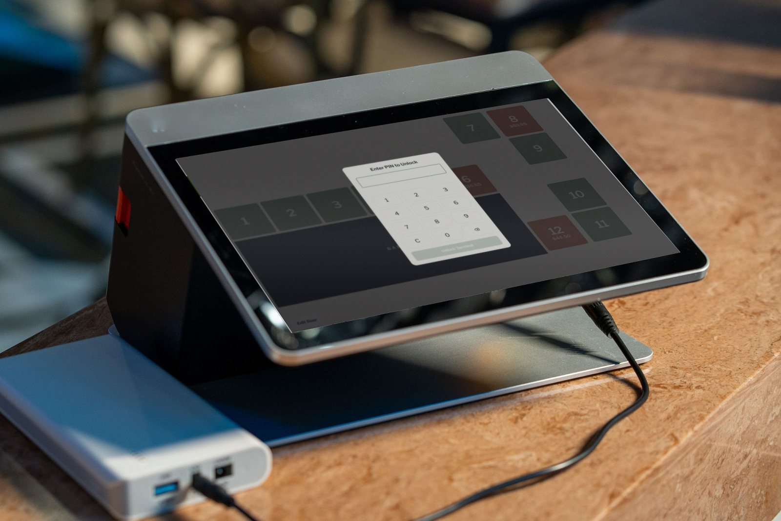 Countertop terminal showing the floor plan of tables, with the staff PIN keypad open